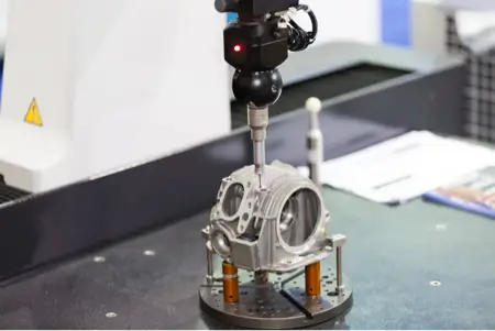 A Coordinate Measuring Machine (Cmm) Probe Inspects A Metallic Component, Mounted On A Rotary Table, In A Modern Quality Control Lab. The Setup Highlights Precision Engineering And Automated Inspection Processes.