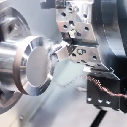 Close-Up Of A Metal Lathe Machine In Operation. The Lathe Is Cutting And Shaping A Cylindrical Piece Of Metal, Producing Fine Shavings And Sparks. The Prototype Cnc Turning Process Highlights The Detailed Metal Workpiece And Cutting Tool, Showcasing Precision Machining Work.