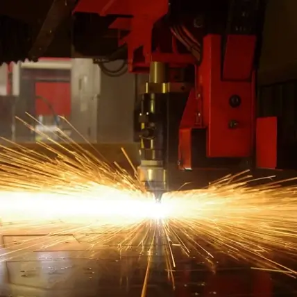 A Cnc Machine Is Actively Cutting Through A Sheet Of Metal, Producing A Shower Of Bright, Intense Sparks. The Glowing Sparks Fan Out Across The Workspace, Highlighting The Precision And Intensity Of This Prototype Laser Cutting Process.