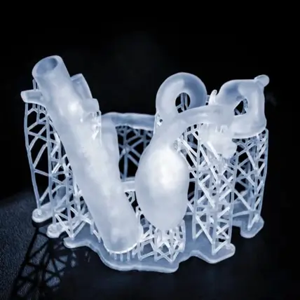 A Translucent, Intricate 3D-Printed Object Made Of Clear Resin, Resembling A Complex Piping Structure With A Mix Of Straight And Curved Tubes. The Object Is Supported By A Detailed Lattice Framework, Set Against A Dark Background—An Exquisite Example Of Sla 3D Printing Service Craftsmanship.