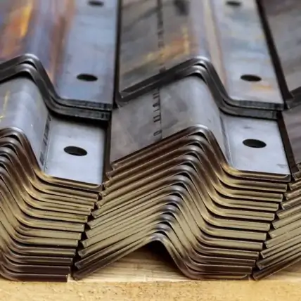 A Close-Up Image Shows A Stack Of Prototype Sheet Metal Bent Into Right-Angle Shapes. The Sheets Are Uniform In Size With Two Holes On One Side. The Edges And Corners Appear Smooth And Precisely Cut. The Shiny Metallic Surface Reflects Light, Highlighting The Material.