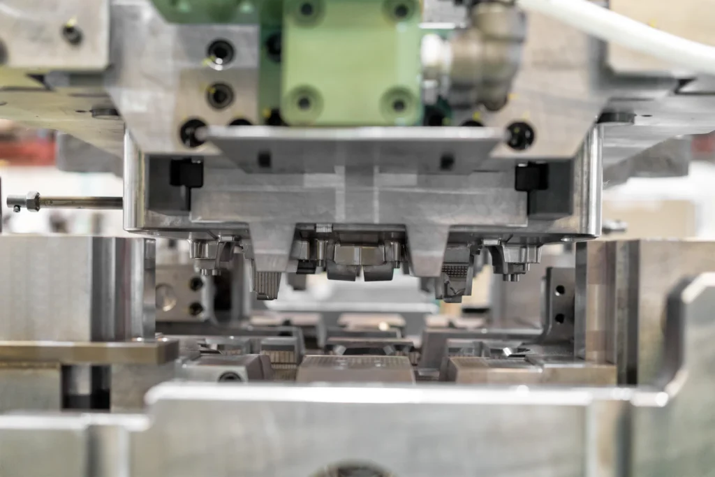 A Close-Up View Of Industrial Machinery Parts, Showcasing Metal Components And Gears. The Equipment Appears To Be Designed For Precision Engineering Or Manufacturing Processes. The Focus Is On The Intricate Details Of The Machinery.