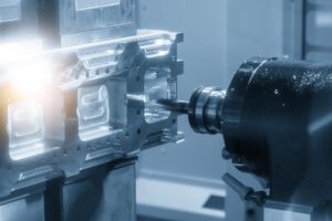 A Close-Up Of A Cnc Machine Operating On A Metallic Piece, With A Drill Bit Penetrating The Metal. The Background Is Blurred, Emphasizing The Precision Of The Machining Process. A Bright Light Highlights Part Of The Metal Surface.