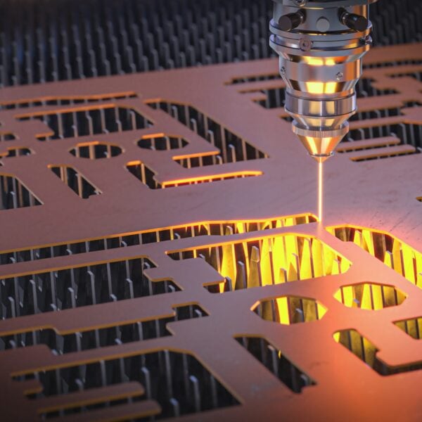 Close-Up Of A Laser Cutting Machine Precisely Cutting Shapes Out Of A Sheet Of Metal, With Bright Light And Sparks Illuminating The Area Being Cut.