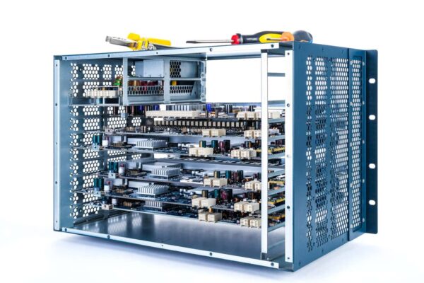 A Partially Assembled Electronic Rack With Circuit Boards And Components, Metal Frame, And Various Hand Tools Including A Screwdriver And Pliers Resting On Top, Showcases Custom Rackmount Enclosures, Isolated On A White Background.